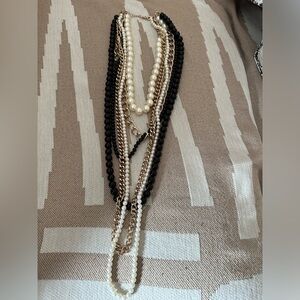 Costume jewelry pearl and gold chains and black beads